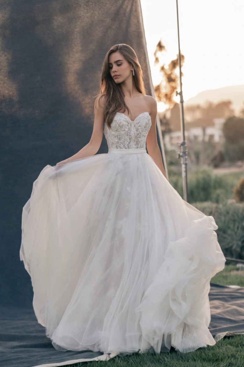 Allure Couture Style C726 | Organza overskirt of this strapless sweetheart ballgown barely hints at the continuation of the richly sequined lace featured along the bodice.